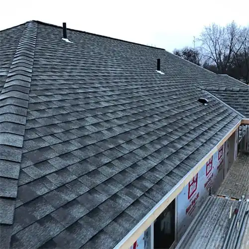 roofing repairs and replacements in Minneapolis, MN. Photo shows a newly installed shingle roof